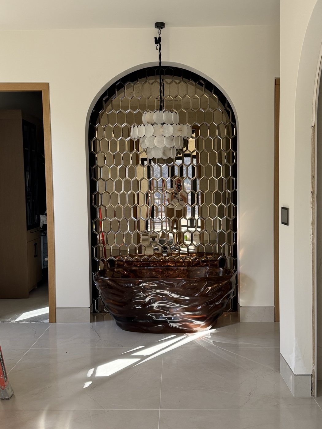 Architectural arched mirror and statement fixture