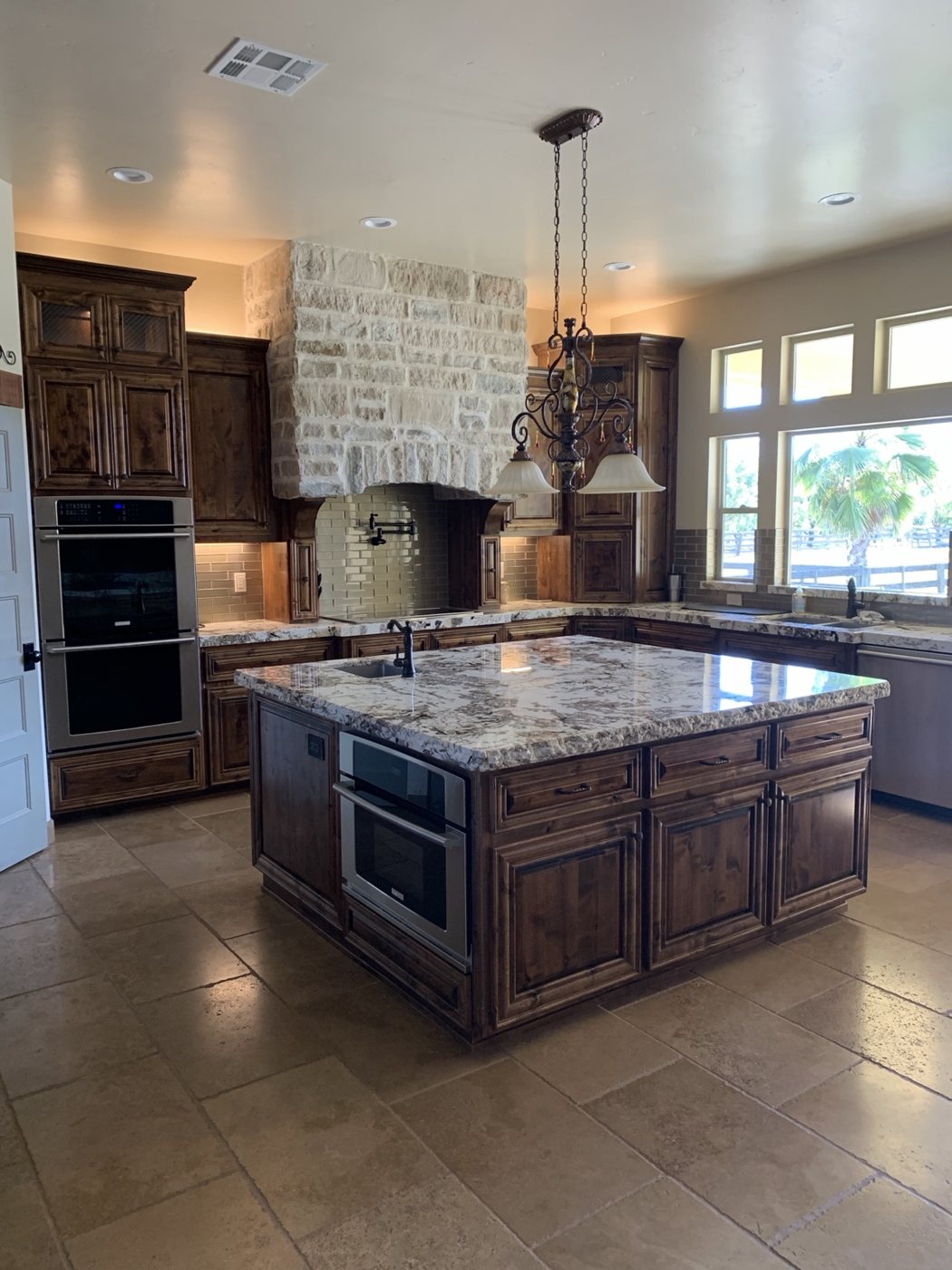 Kitchen with dark wood cabinetry and stone island